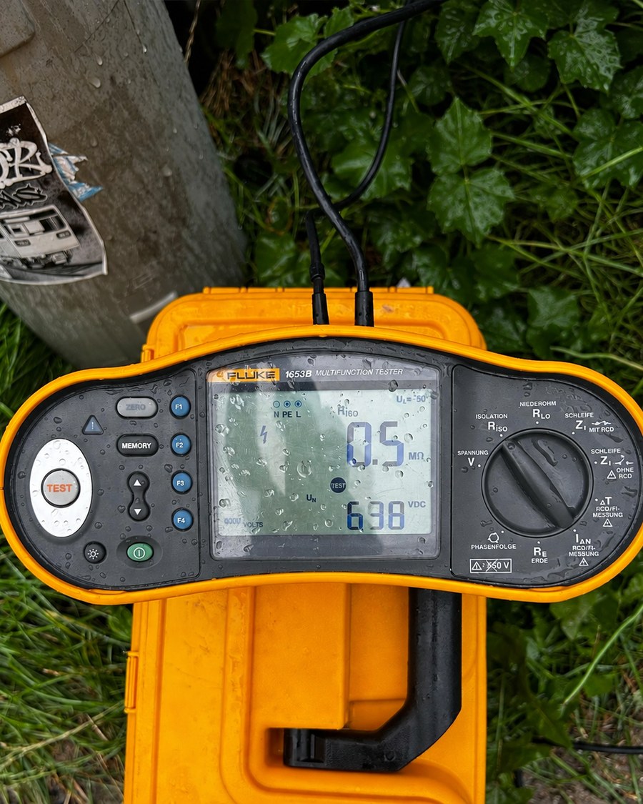 Gelbes Prüfgerät bei der Messung einer elektrischen Anlage
